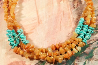 Stunning 3 strand Necklace featuring Genuine Carnelian with accents of Sleeping Beauty Turquoise.  Sterling Silver Beads, Cones and Clasp. Created by Santo Domingo Artist Carol Pacheco. The Santo Domingo Pueblo is in New Mexico, near Santa Fe.